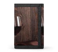 Bouteille de vin rouge, deux verres, bougie et roses rouges sur bois marron, portefeuille à trois volets, porte-monnaie élé avec porte-clés, porte-cartes de crédit pour factures, reçus, femmes et