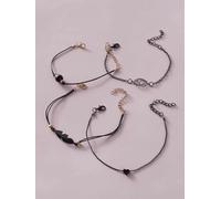 Bracelet de cheville à breloques noires et dorées pour femme - 4 pièces bijoux de pied réglables avec cœur, lotus, plumes et perles noires - Style bohème tendance, parfait pour l'été
