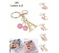 Ce porte-clés élégant de couleur or est décoré de fleurs de cerisier roses, avec des pendentifs de lettres 3D de A à Z. Il peut être accroché aux sacs à main et aux sacs à dos, en en faisant un cadeau