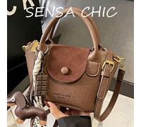 Ce sac à main pour femme est en PU de couleur café avec un design à la mode et polyvalent. Il présente une fermeture éclair lisse, des poignées doubles, une décoration de lettre, un charme de teckel e