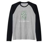 Citation inspirante pour Les Amoureux de l'humeur Still Beating Resilience Manche Raglan