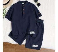 Ensemble deux pièces pour garçon de style de vacances d'âge intermédiaire, comprenant un t-shirt à manches courtes avec boutonnière à moitié fermée, un col montant, une application et un short en tiss