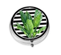 Feuille de palmier verte. Cette petite boîte à pilules ronde est un organisateur de médicaments de voyage portable avec trois compartiments pour ranger les médicaments quotidiens.