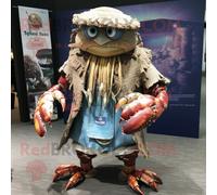 Hermit Crab Personnage De Costume De Mascotte Redbrokoly Habillé Avec Un T-Shirt Henley Et Des Bracelets Multicolore