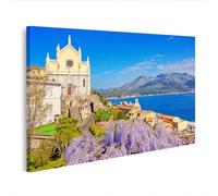 islandburner Impression sur toile - Belle vue sur la côte avec fleurs et église historique - Toile 100 x 57 cm