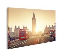 islandburner Impression sur toile Motif trafic sur la route devant l'horloge de la tour historique au coucher du soleil - Toile 100 x 57 cm