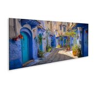 islandburner Tableau sur toile - Ruelle pittoresque à Chefchaouen avec murs bleus et plantes - Panorama