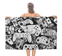 Manettes de jeux vidéo : un voyage visuel à travers l'histoire du jeu vidéo. Serviettes de plage extra-larges, ultra-absorbantes et à séchage rapide, qualité hôtelière de luxe, 130 cm x 80 cm.