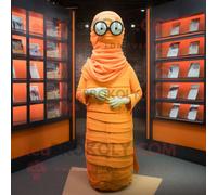 Mascotte Redbrokoly De Personnage De Momie Orange Vêtue D'une Robe Longue Et De Lunettes De Lecture Multicolore