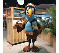 Mascotte Redbrokoly De Personnage De Toucan Marron Habillé D'un Short En Jean Et De Mitaines Multicolore