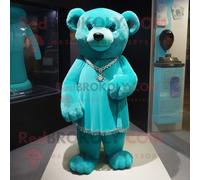 Mascotte Redbrokoly De Personnage Ours Cyan Habillé D'une Robe Fourreau Et De Boucles D'oreilles Multicolore