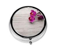 Orchid Cette petite boîte à pilules ronde imprimée est un organisateur portable de pilules et de vitamines, parfait pour les poches, les sacs à main et les voyages.