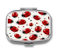 Petit pilulier en forme de coccinelle rouge avec deux compartiments en métal pour médicaments