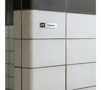 Plaque signalétique gravée autocollante Toilettes - blanc écriture noire - format 12x3,7 cm