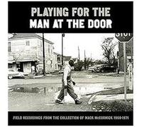 Playing For The Man At The Door