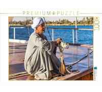 Puzzle · Le Capitaine se concentre sur Le Pilotage | Naviguer sur le Nil avec un Dahabeya · 1000 pièces · Format assemblé 64 × 48 cm · CALVENDO Puzzle