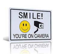 Signe humoristique « Smile You're on Camera » avec inscription « Caution and Notice »