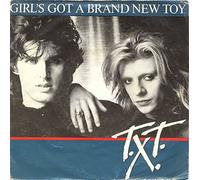 T.X.T. - Girl`s Got A brand New Toy/Hot Was The Rainy Night(7" Vinyl Single)(1985)(CBS A 6073)