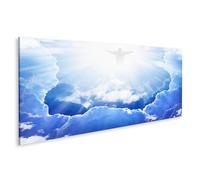 Tableau sur toile Jésus-Christ dans un ciel bleu avec des nuages, une lumière vive venant du ciel - Toile 120x40 cm - Panorama