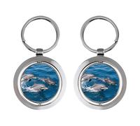 Trois dauphins nagent dans le porte-clés rotatif en acier inoxydable