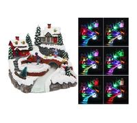 Village de Noël lumineux avec patineur animé